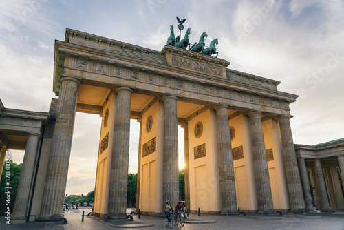 Photography Two cyclists in Brandenburg gate at sunset, Berlin, Germany