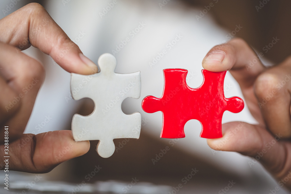 Two hands of businessman to connect couple puzzle piece. symbol of association and connection. business strategy. Two hands of businessman to connect couple puzzle piece. symbol of association and connection. business strategy.