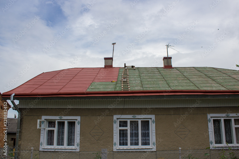 painting the roof at home,repaint the green roof in red, part of the painted roof
