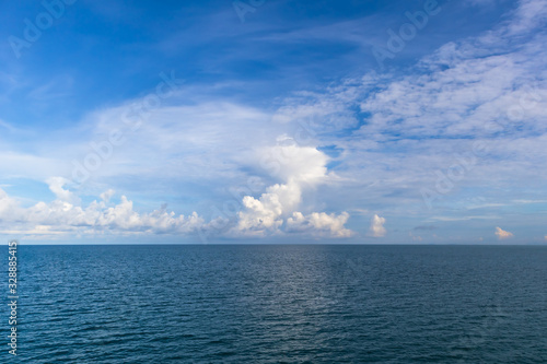 Blue sky with white cloud and deep blue sea