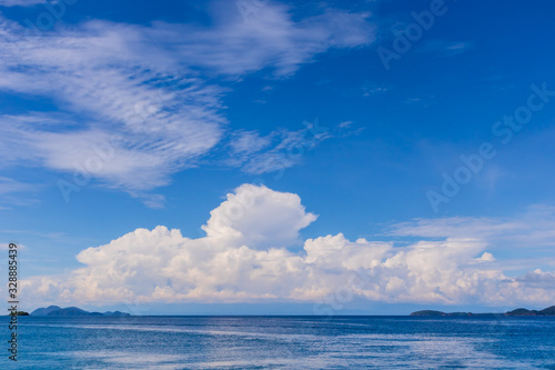 Blue sky with white cloud and deep blue sea