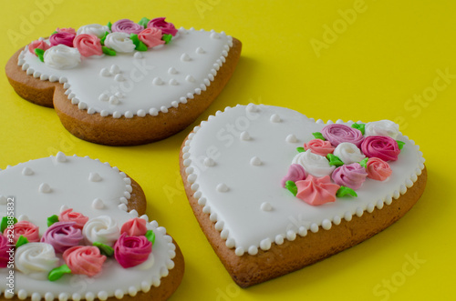 Gingerbread hearts on yellow background. Ginger biscuits.