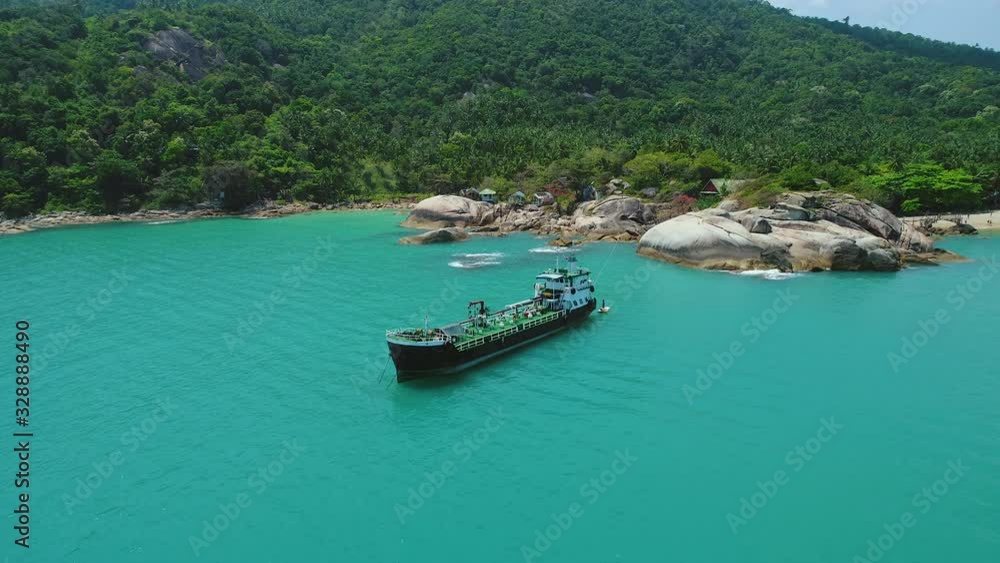 Exotic Island Cargo Ship In Harbor Aerial View. Epic Tropical Beach Scenery Turquoise Ocean Water Surface Above. Asian Marine Seascape Mount Hill Covered by Wood Trees Travel Concept Thailand 4K Exotic Island Cargo Ship In Harbor Aerial View. Epic Tropical Beach Scenery Turquoise Ocean Water Surface Above. Asian Marine Seascape Mount Hill Covered by Wood Trees Travel Concept Thailand 4K