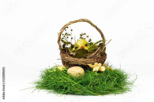 Green nest with straw basket and Easter chicken inside isolated on white backtround photo