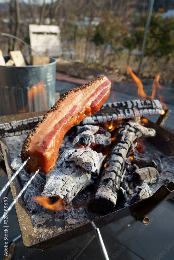 Baking bacon on a bonfire