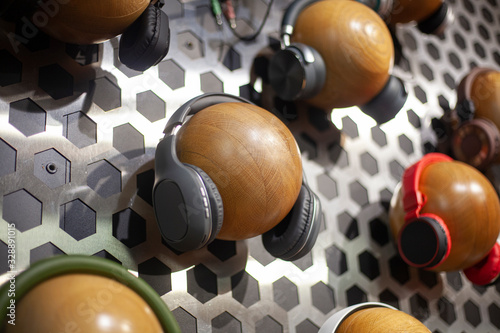 Headphones in a music store. Dummies for demonstrating audio with an earpiece. Spherical objects on which audio devices are dressed. Exhibition of different models 
