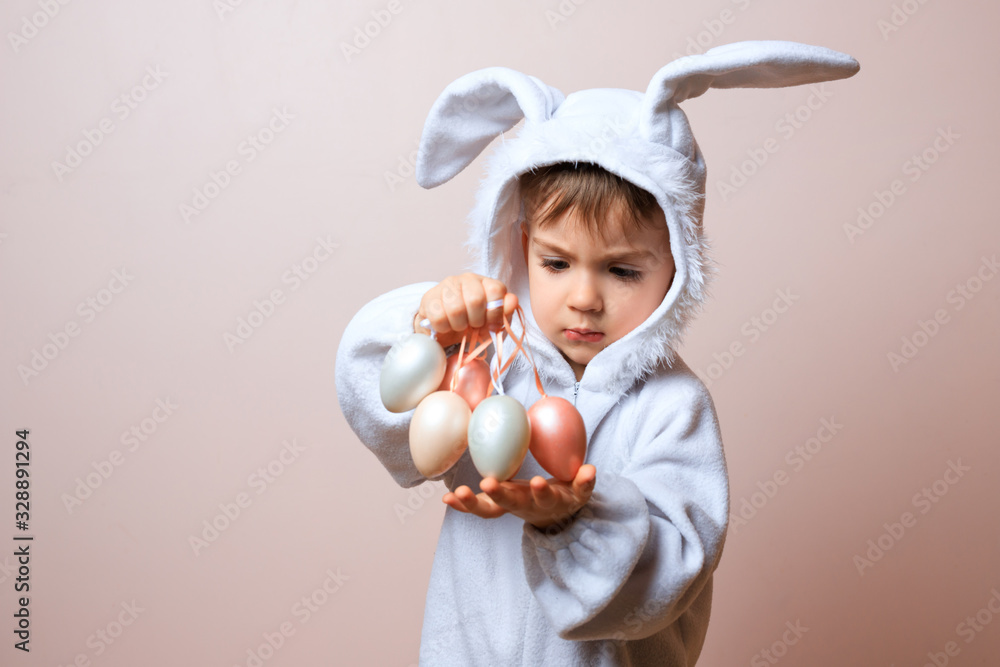 Cute little child boy wearing bunny costume on Easter day. Boy with Easter eggs in the basket. Cute little child boy wearing bunny costume on Easter day. Boy with Easter eggs in the basket.
