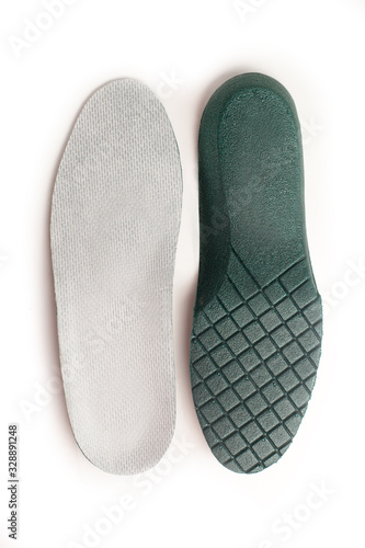 Isolated orthopedic insole on a white background. Treatment and prevention of flat feet and foot diseases. Foot care, comfort for the feet. Wear comfortable shoes.