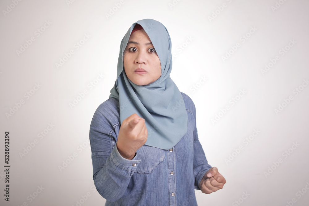 Muslim Woman Pointing at Camera with Angry Expression, Giving Warn Muslim Woman Pointing at Camera with Angry Expression, Giving Warn