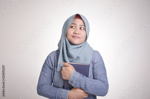 Muslim Woman Reading Book and Thinking