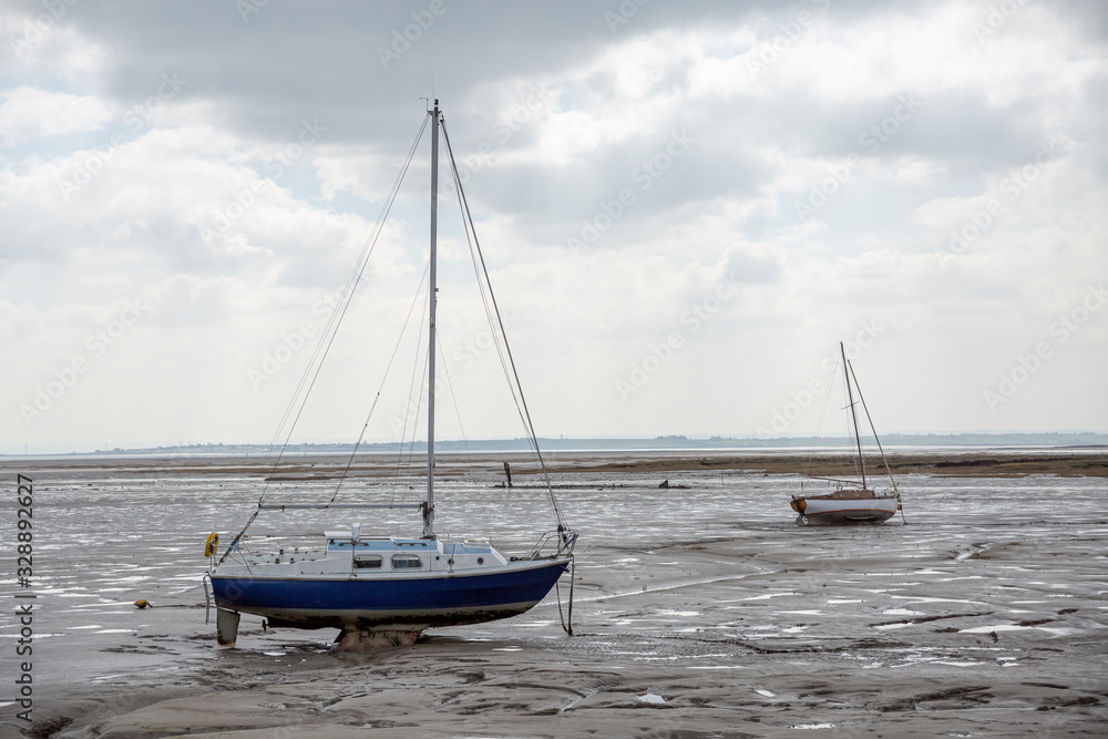 Fisherman boats stuck on the beach in low tide period. Fisherman boats stuck on the beach in low tide period.