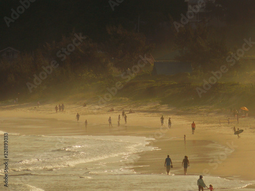 people walking on beach at sunset © Gabriel