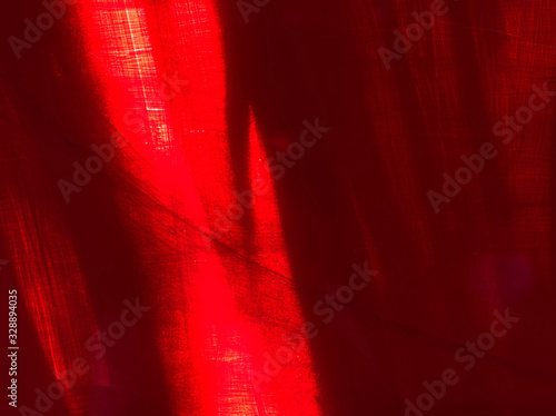 Red blackground of colour painting on concreat wall with streaks of sunlight.