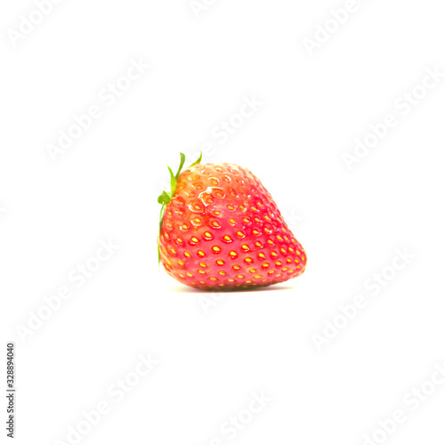 Side view of single  fresh strawberry with leaf isolated on white background.