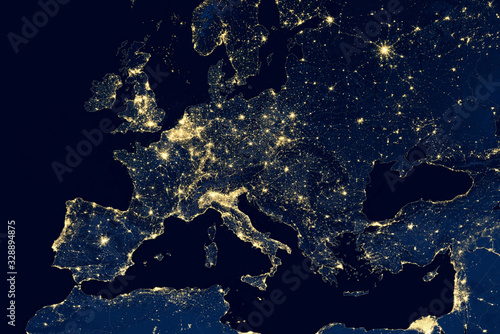 Obraz na płótnie Earth at night, city lights showing human activity in Europe from space. Elements of this image furnished by NASA. w salonie