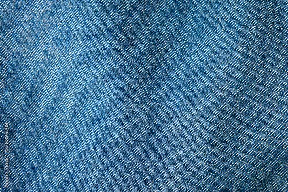 Selective focus blue jean denim top view close up shot to the detail of fabric. textile material and cotton patter tough and durable garment style. For background or wallpaper with copy space for text Selective focus blue jean denim top view close up shot to the detail of fabric. textile material and cotton patter tough and durable garment style. For background or wallpaper with copy space for text