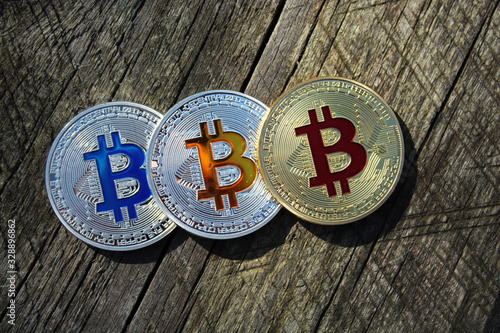 Bitcoins in a row on a Wood Background. Blockchain technology, bitcoin mining concept.