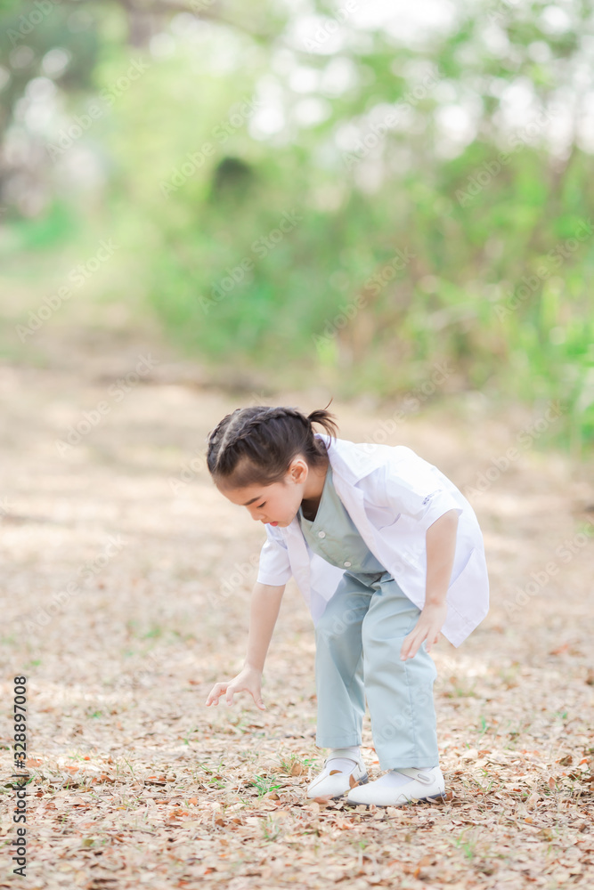 Asian little boy and girl in a doctor suit in Garden