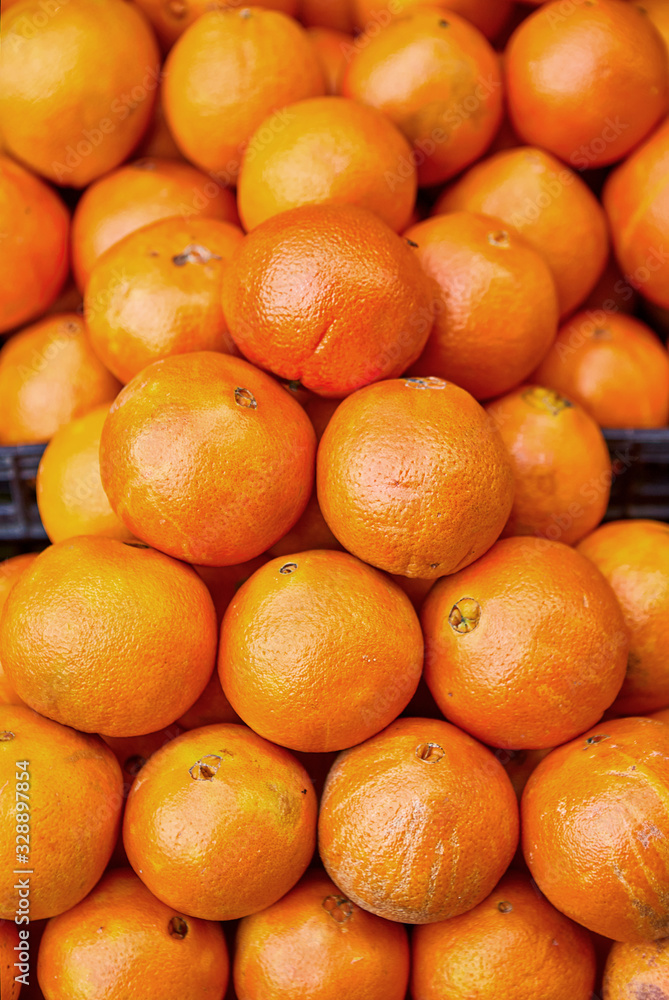 Oranges in the market. Ripe, fresh, yellow oranges are sold in the grocery store market Oranges in the market. Ripe, fresh, yellow oranges are sold in the grocery store market
