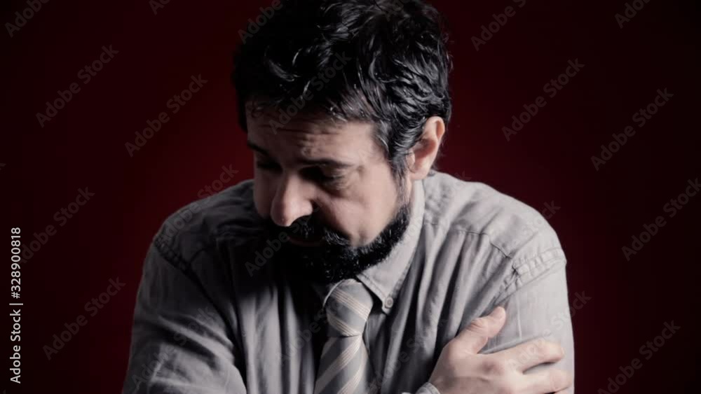A depressed, powerless man's expression. Shot with artistic intentional darkness and contrast. Part of a series of depictions of feelings and emotions with professional actors. A depressed, powerless man's expression. Shot with artistic intentional darkness and contrast. Part of a series of depictions of feelings and emotions with professional actors.