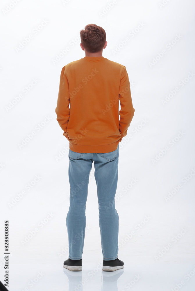 Fototapeta premium rear view. casual young woman looking at white wall