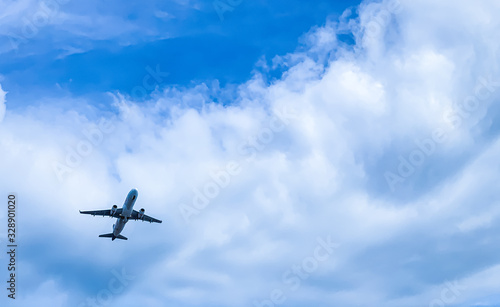 airplane flying tacking off over head to blue sky and cloud.