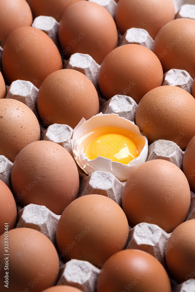 Carton eco box with natural farm eggs with one yolk in a shall. Natural background. Social concept Carton eco box with natural farm eggs with one yolk in a shall. Natural background. Social concept