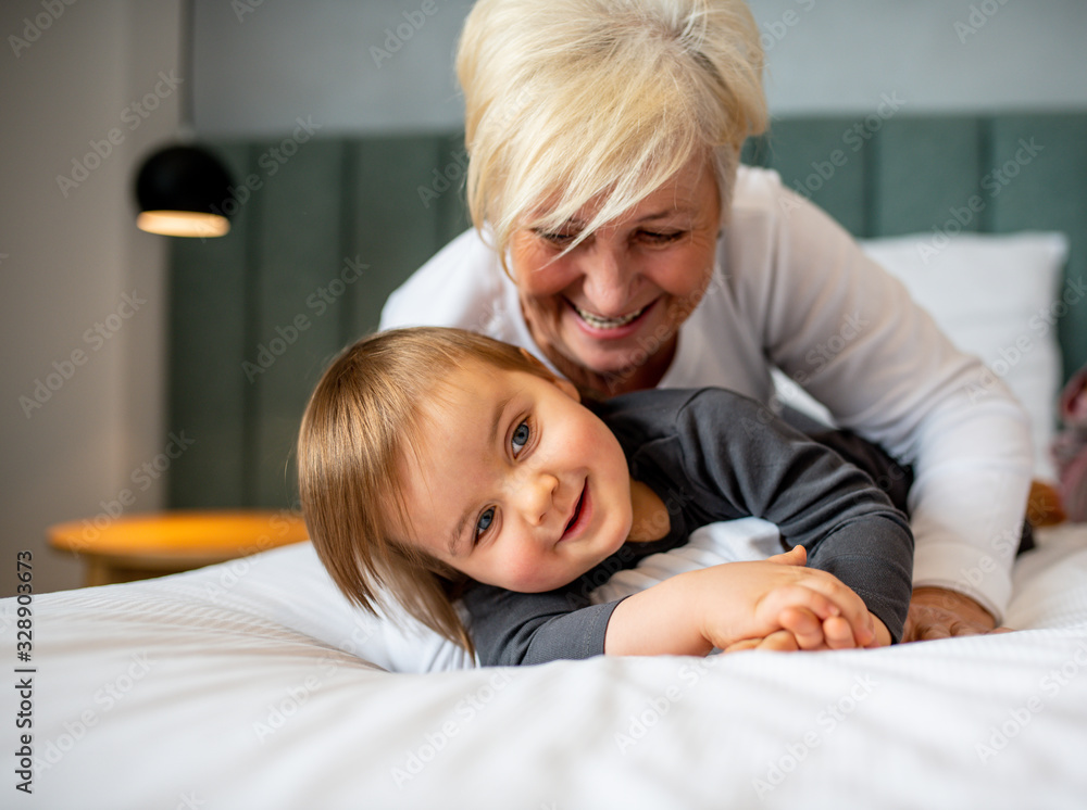 Grandma hugging her grandson while laying down. Grandma hugging her grandson while laying down.