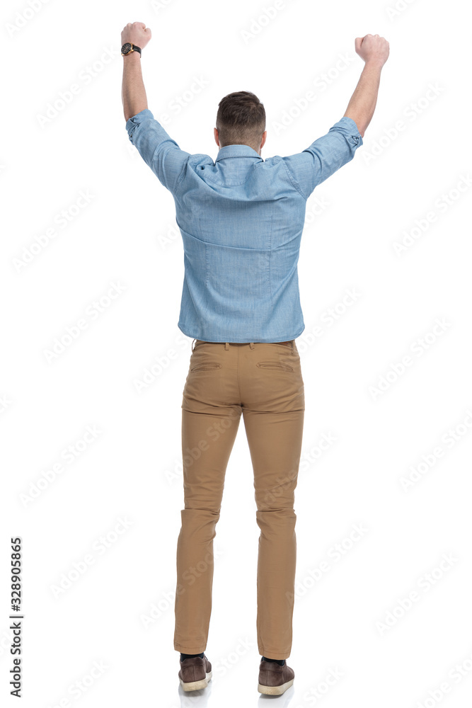 Rear view of positive casual man celebrating Rear view of positive casual man celebrating