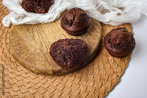 Chocolate muffins. Delicious cupcakes on white table.