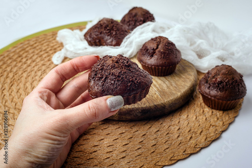 Chocolate muffins. Delicious cupcakes on white table.