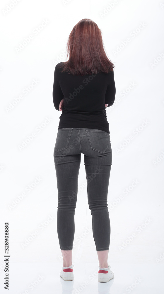 rear view . casual young woman looking at white screen rear view . casual young woman looking at white screen