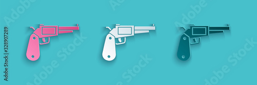 Paper cut Revolver gun icon isolated on blue background. Paper art style. Vector Illustration