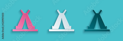 Paper cut Traditional indian teepee or wigwam icon isolated on blue background. Indian tent. Paper art style. Vector Illustration