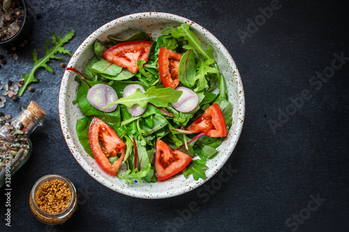 healthy salad tomato, mix leaves, onions and other ingredients, vegan, keto or paleo menu concept. top food background. copy space