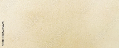 Fototapeta close up retro plain cream color cement wall panoramic background texture for show or advertise or promote product and content on display and web design element concept 
