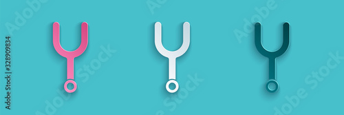 Paper cut Musical tuning fork for tuning musical instruments icon isolated on blue background. Paper art style. Vector Illustration