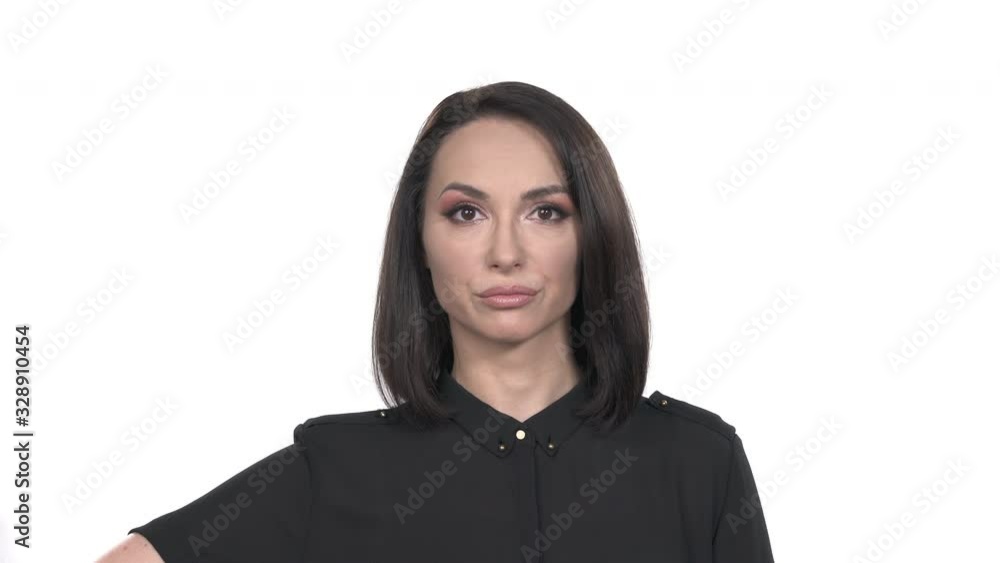 Woman pointing at camera and expressing negative emotions by placing index finger to her forehead temple. Body language and gestures concept. Portrait shot, isolated, on white background Woman pointing at camera and expressing negative emotions by placing index finger to her forehead temple. Body language and gestures concept. Portrait shot, isolated, on white background