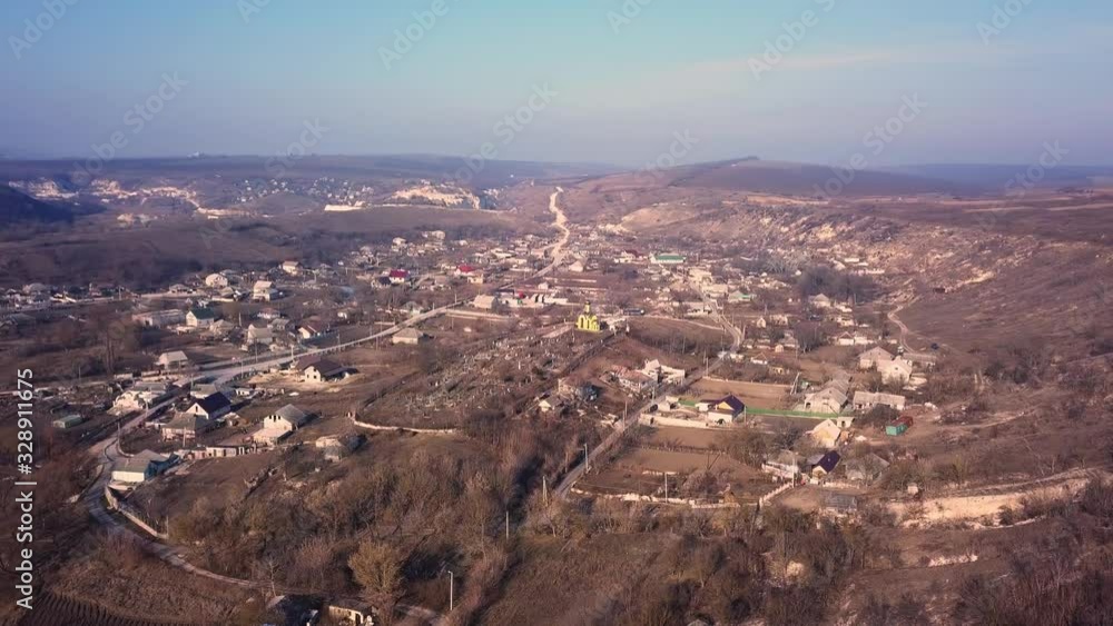 Flight over the small village with small church in center. Sunny spring day. Flight over the small village with small church in center. Sunny spring day.