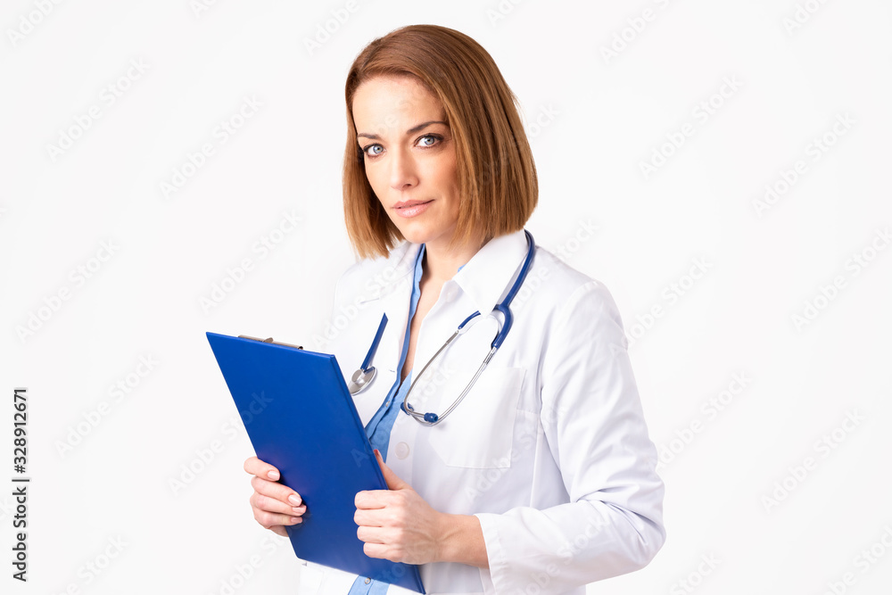 Portrait of middle aged female doctor standing at isolated white background Portrait of middle aged female doctor standing at isolated white background
