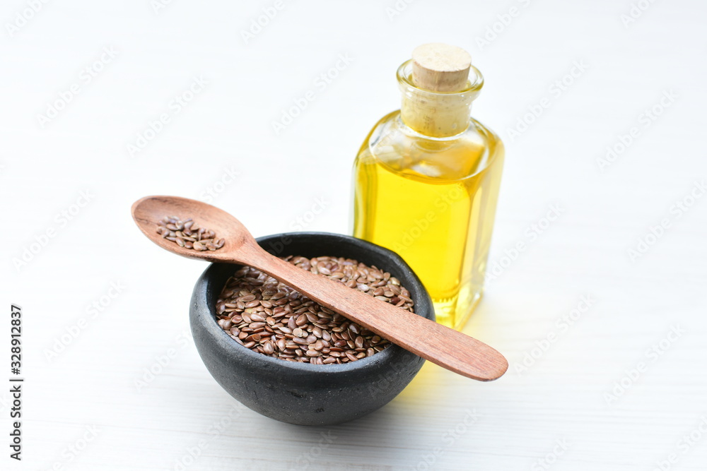 Flaxseed or flaxseed seeds, accompanied by oil (Linum usitatissimum) displayed in containers