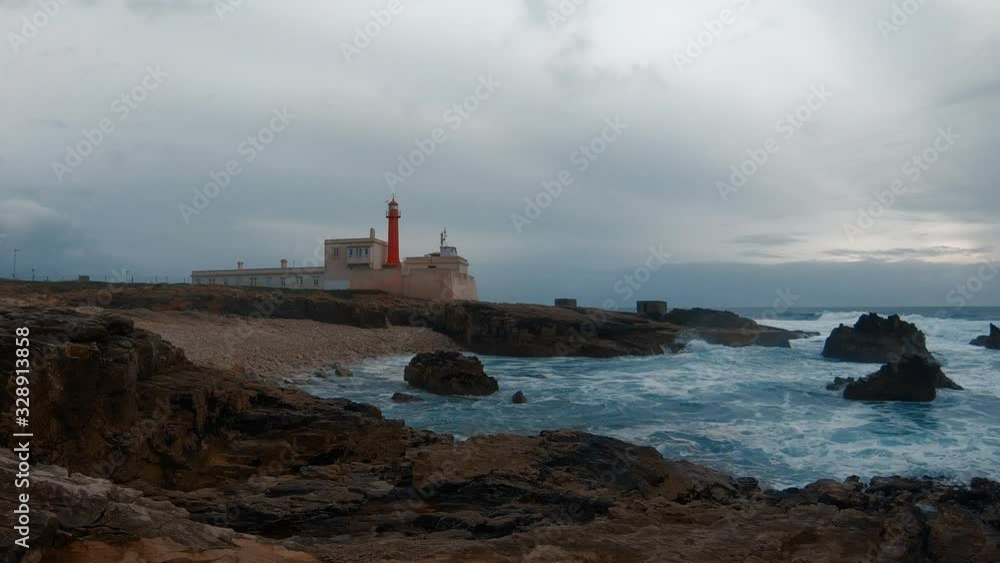 Rocky beach with a Lighthouse in a stormy day. Moving clouds, timelapse Rocky beach with a Lighthouse in a stormy day. Moving clouds, timelapse