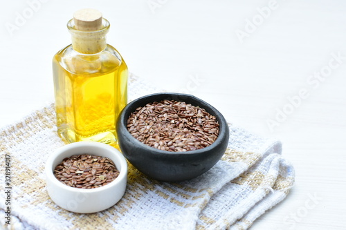 Flaxseed or flaxseed seeds, accompanied by oil (Linum usitatissimum) displayed in containers