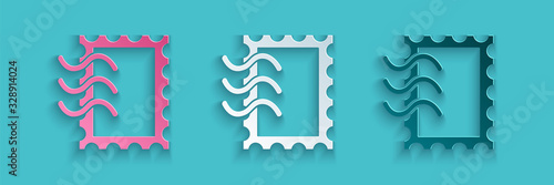 Paper cut Postal stamp icon isolated on blue background. Paper art style. Vector Illustration