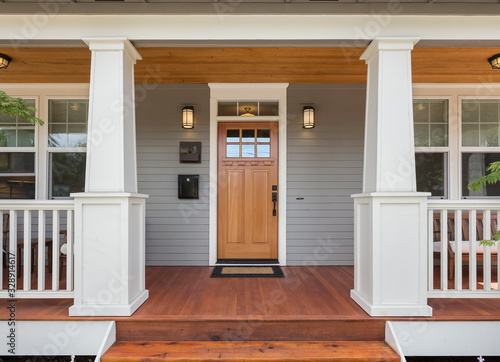 Covered porch and front door of beautiful new home Fototapet