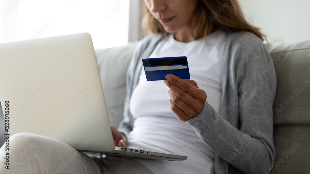 Close up of young woman shopping online on laptop enter credit card bank details, millennial girl make Internet purchase buy things goods on web using digital banking system, easy service concept Close up of young woman shopping online on laptop enter credit card bank details, millennial girl make Internet purchase buy things goods on web using digital banking system, easy service concept