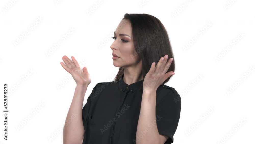 What is going on? gesture. Portrait of confused woman standing with raised up hands, posing at camera. Isolated, on white background What is going on? gesture. Portrait of confused woman standing with raised up hands, posing at camera. Isolated, on white background