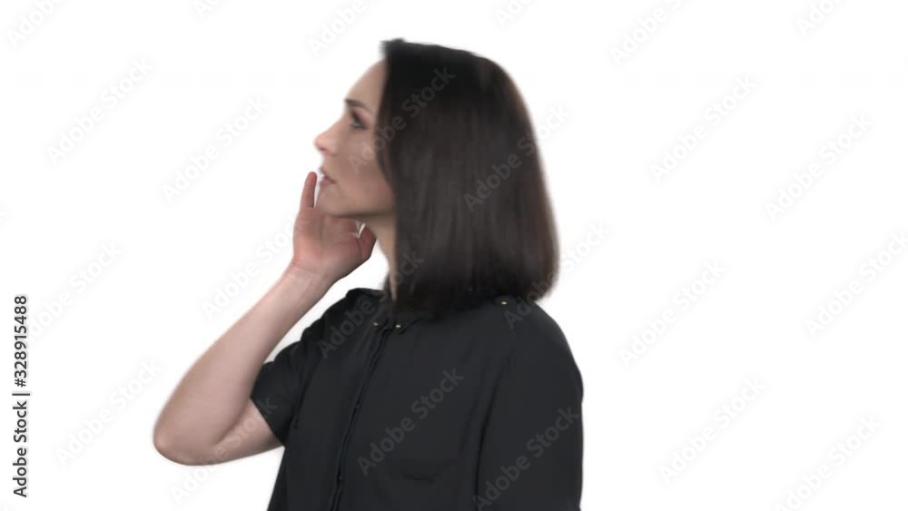 I cannot hear you gesture. Beautiful young woman hearing something, trying to understand words. Studio shot, white background I cannot hear you gesture. Beautiful young woman hearing something, trying to understand words. Studio shot, white background
