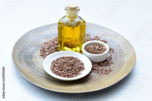 Flaxseed or flaxseed seeds, accompanied by oil (Linum usitatissimum) displayed in containers