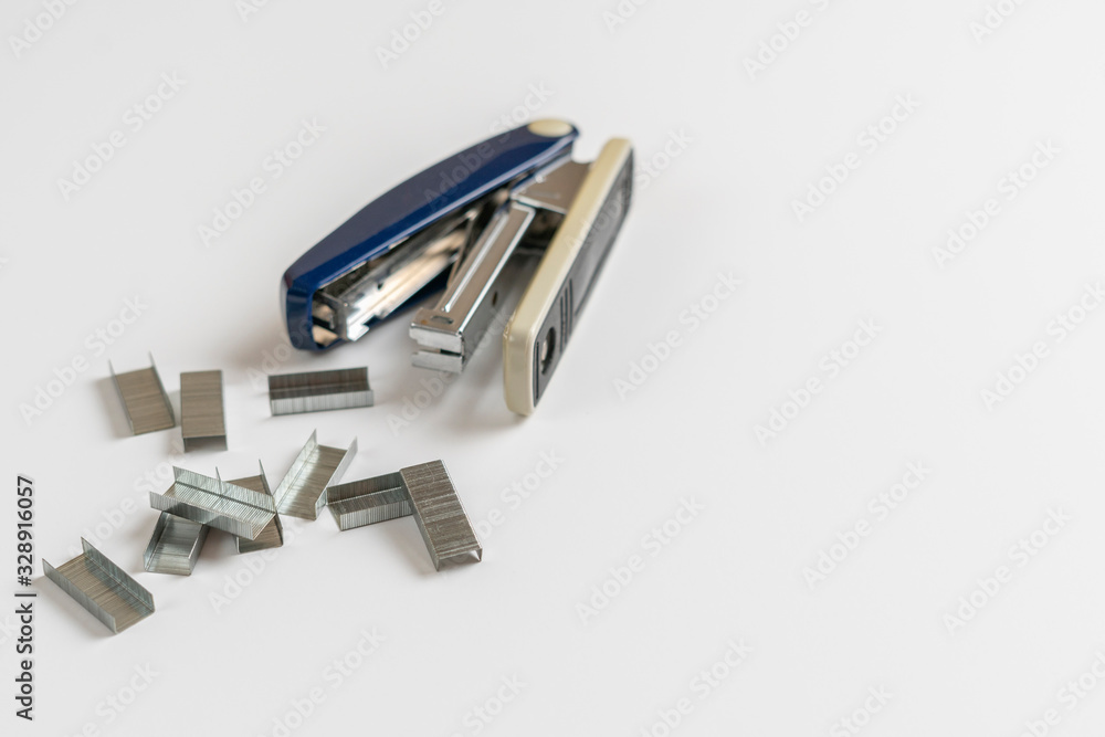 simple stapler and staples isolated on the colorful background in office table simple stapler and staples isolated on the colorful background in office table